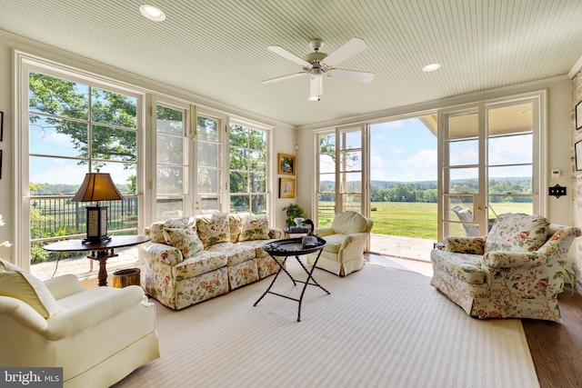 sunroom / solarium featuring ceiling fan