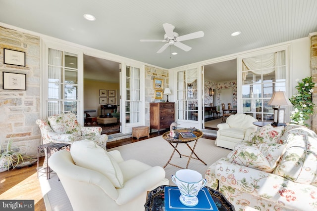 living room with ceiling fan, light wood-type flooring, and french doors