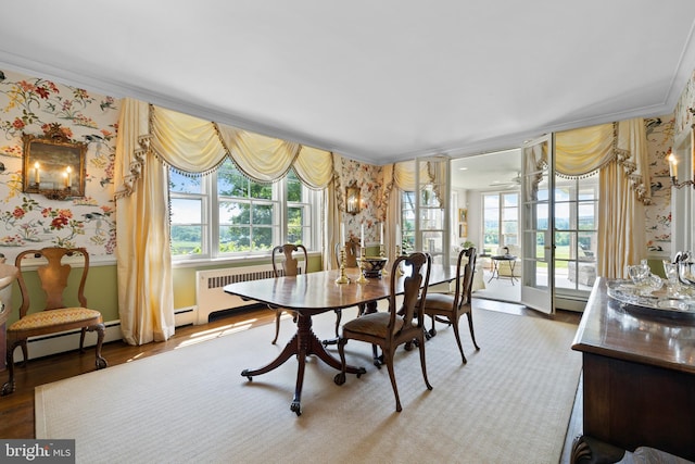 dining space featuring light hardwood / wood-style floors, a baseboard heating unit, french doors, radiator, and ornamental molding