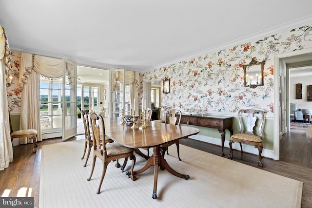 dining space with a baseboard radiator, a notable chandelier, crown molding, and dark wood-type flooring