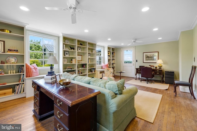 living room featuring crown molding, ceiling fan, and light hardwood / wood-style flooring