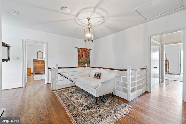 living room with a baseboard heating unit and light hardwood / wood-style flooring