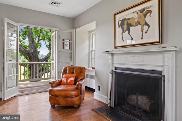 living area featuring radiator heating unit and dark wood-type flooring