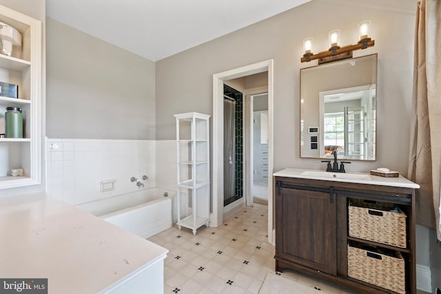 bathroom featuring vanity, tile flooring, and independent shower and bath