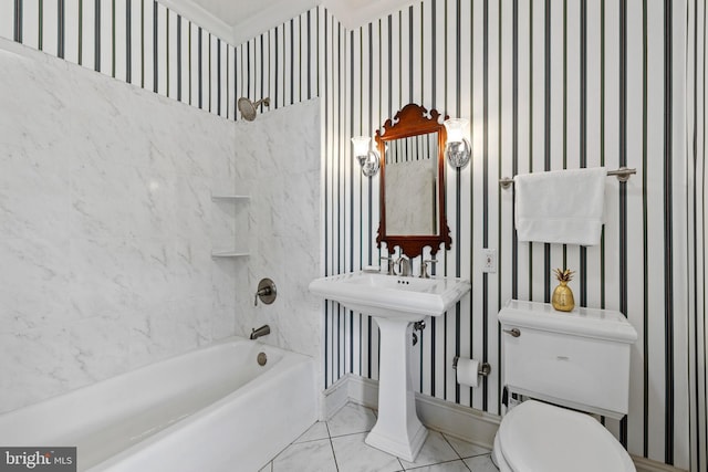 bathroom featuring tile floors, toilet, and tiled shower / bath