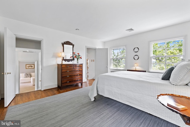 bedroom featuring dark hardwood / wood-style flooring