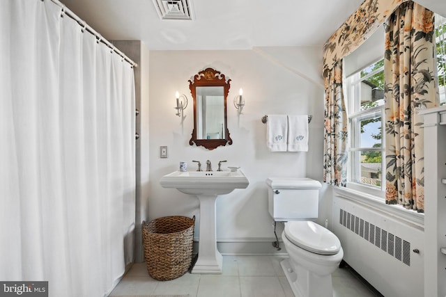 bathroom featuring tile floors, toilet, radiator heating unit, and sink