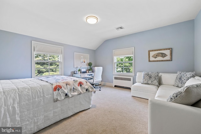 carpeted bedroom with lofted ceiling and radiator heating unit