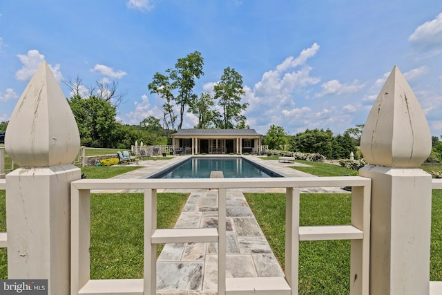 view of swimming pool featuring a yard and a patio area