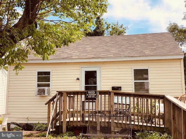 back of house featuring a wooden deck