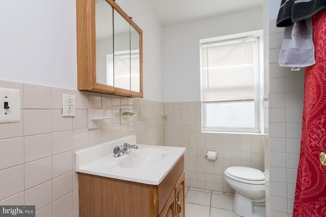 bathroom featuring tile walls, oversized vanity, toilet, and tile floors