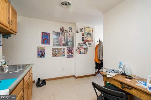 interior space with light tile floors and sink