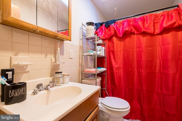 bathroom with tile walls, toilet, vanity, and tasteful backsplash