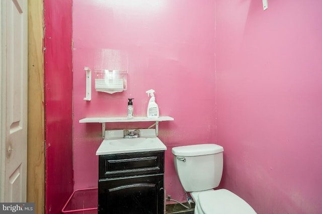 bathroom featuring toilet and vanity