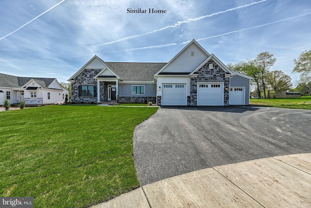 view of front of house featuring a front lawn and a garage