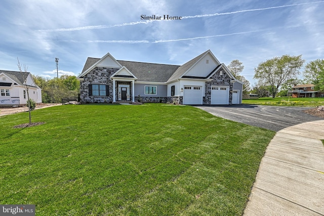 view of front of home with a front lawn and a garage