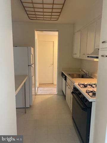 kitchen with white fridge, white cabinetry, gas range oven, stainless steel dishwasher, and sink