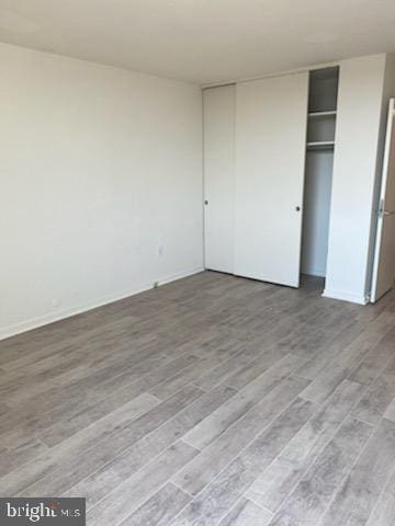 unfurnished bedroom featuring a closet and light hardwood / wood-style floors