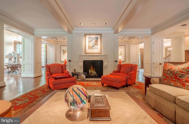 living room with light wood-type flooring, crown molding, and beamed ceiling