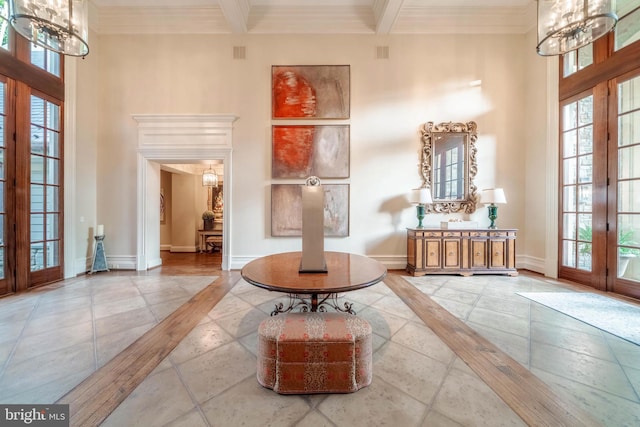 interior space featuring light tile flooring, a notable chandelier, beamed ceiling, and plenty of natural light