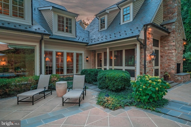 view of patio terrace at dusk