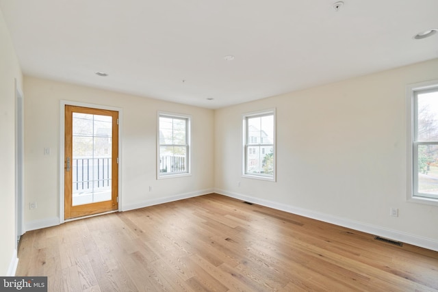 unfurnished room with light hardwood / wood-style floors