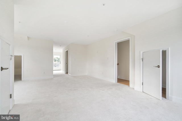 unfurnished room featuring light colored carpet