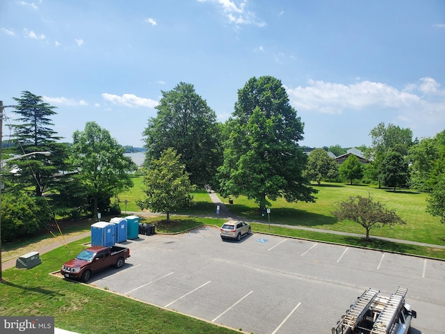 view of car parking with a yard