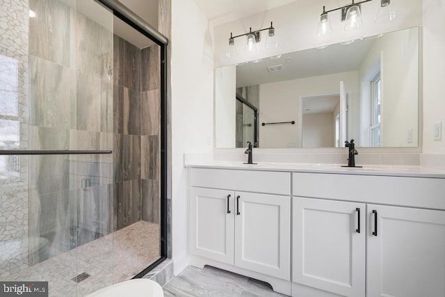 bathroom featuring vanity and an enclosed shower