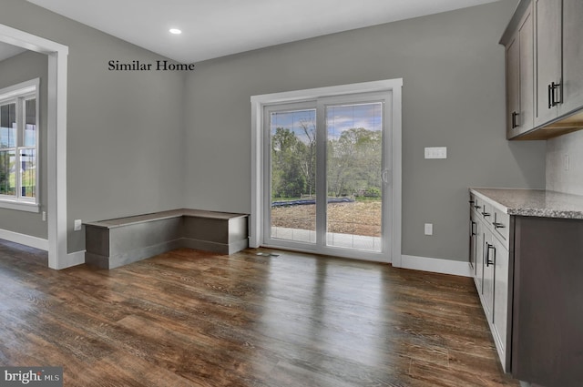 unfurnished dining area featuring dark hardwood / wood-style flooring