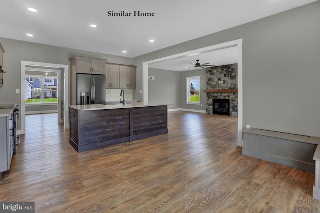 kitchen with stainless steel fridge with ice dispenser, plenty of natural light, and dark hardwood / wood-style flooring