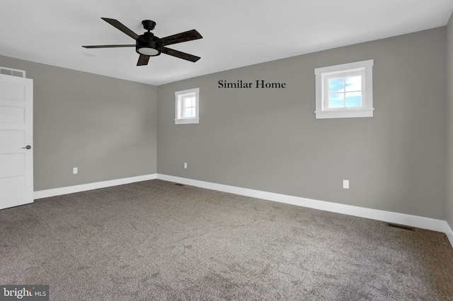 carpeted spare room featuring ceiling fan