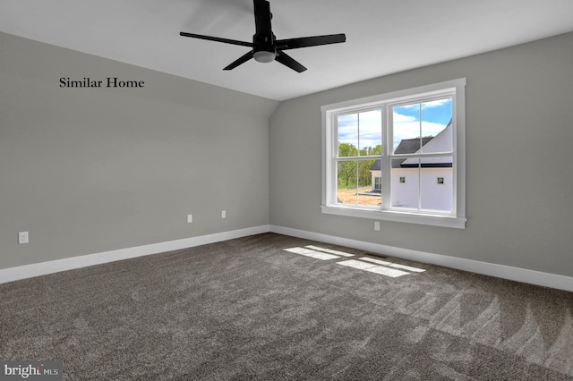 empty room with dark colored carpet and ceiling fan