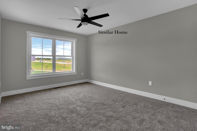 empty room featuring carpet flooring and ceiling fan