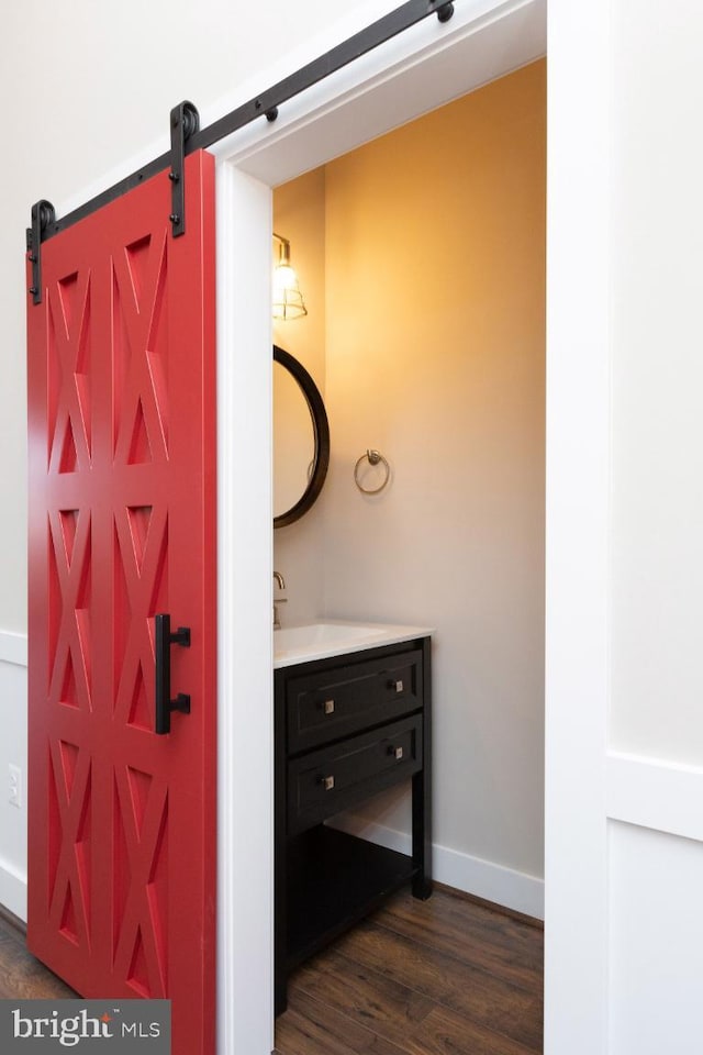 bathroom with hardwood / wood-style floors and vanity