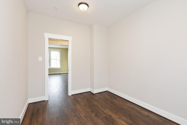 empty room with dark hardwood / wood-style flooring