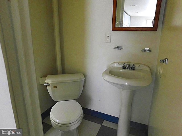 bathroom with toilet and tile flooring