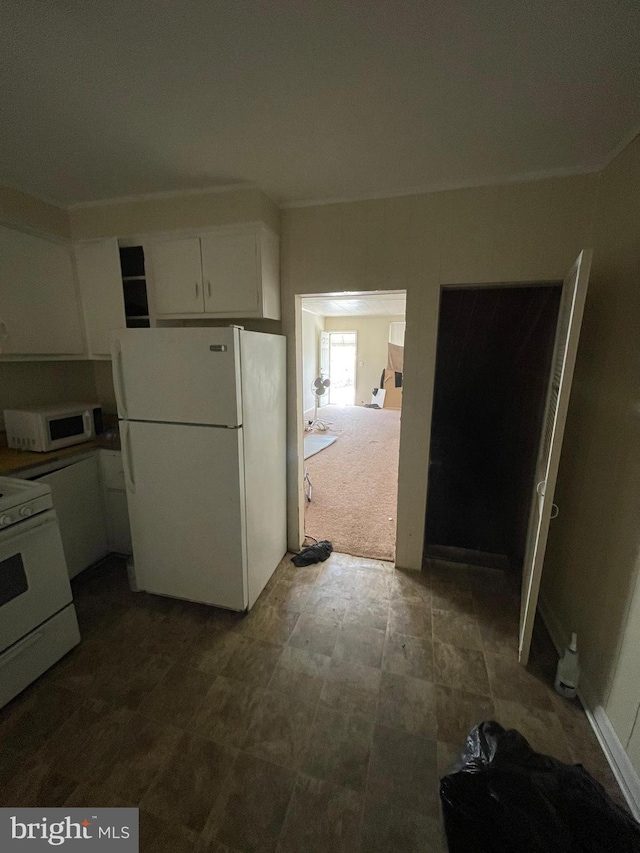 kitchen featuring white appliances, white cabinetry, and tile flooring