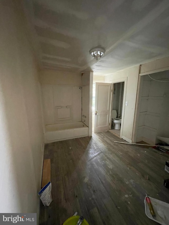 interior space featuring dark hardwood / wood-style flooring and connected bathroom