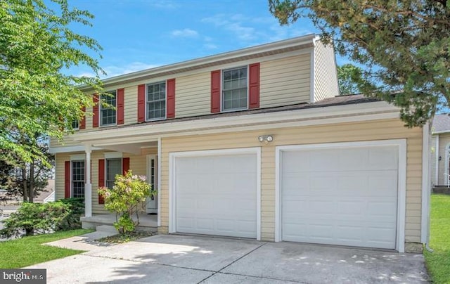 view of front of house with a garage and concrete driveway