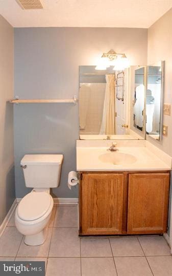 bathroom featuring toilet, vanity, and tile patterned floors