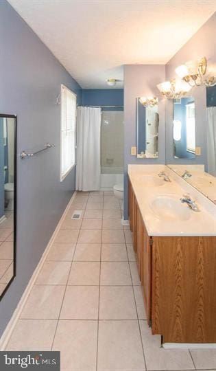 full bathroom with tile patterned floors, vanity, toilet, and shower / tub combo with curtain