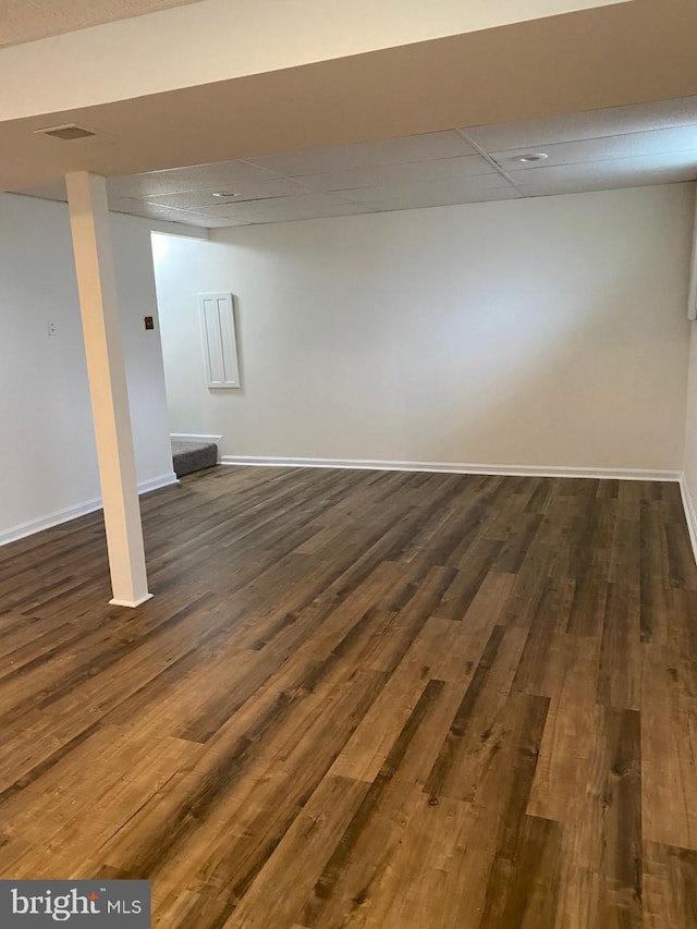 basement featuring dark hardwood / wood-style flooring