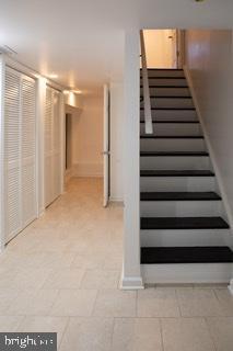 stairway with light tile flooring