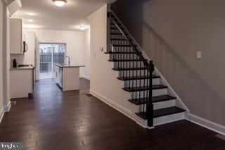 staircase featuring dark hardwood / wood-style flooring