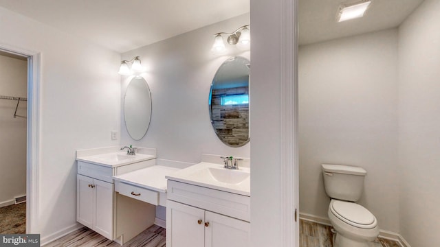 bathroom with toilet and vanity