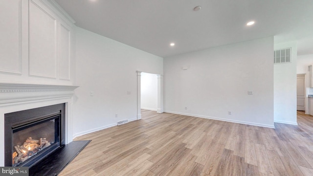 unfurnished living room with light hardwood / wood-style floors