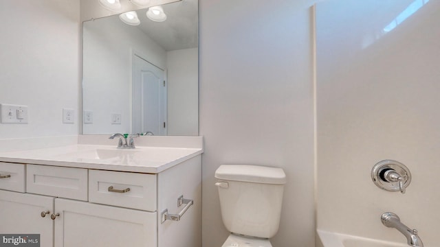 bathroom featuring toilet and vanity