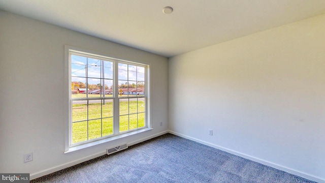 empty room with dark carpet