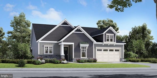 view of front of house with a front yard and a garage